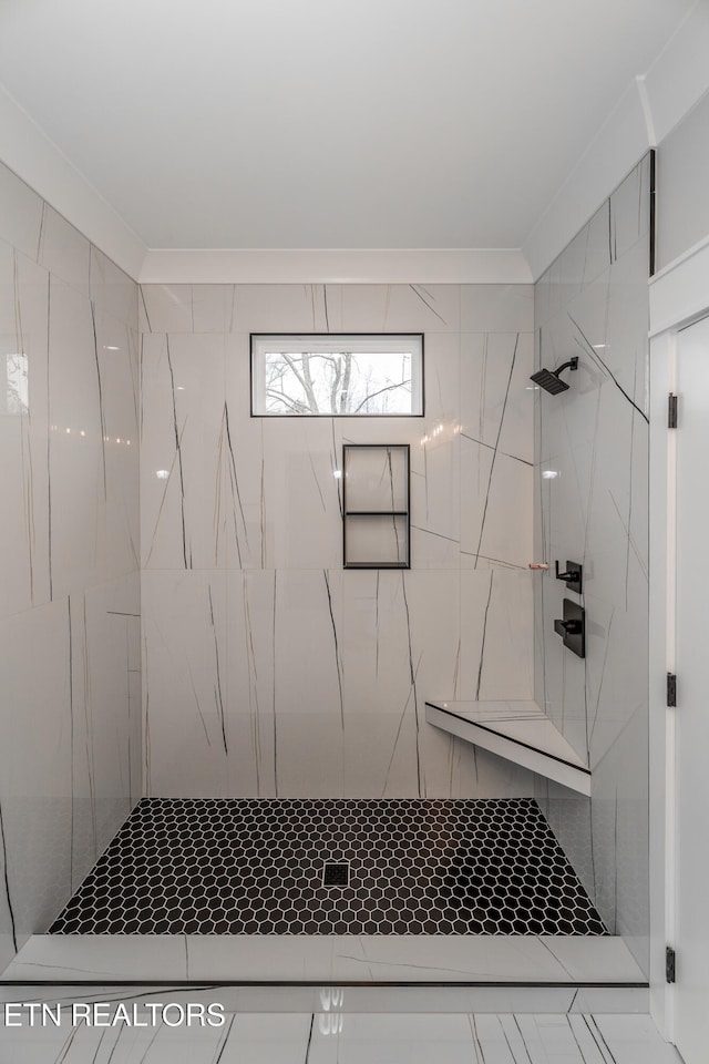 bathroom featuring tiled shower