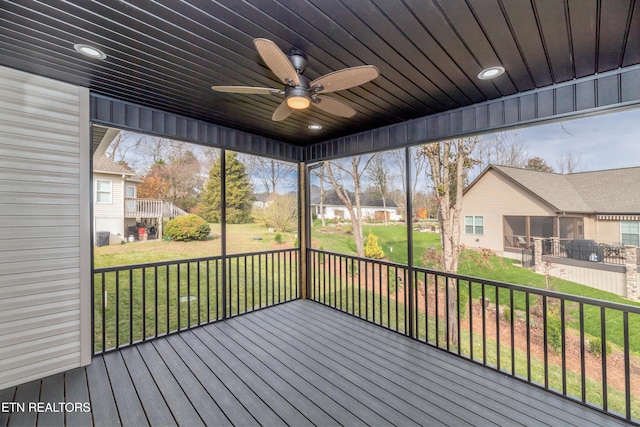 unfurnished sunroom with ceiling fan and a healthy amount of sunlight