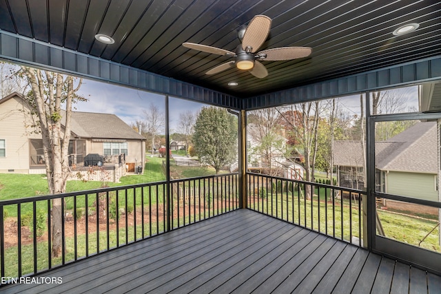 unfurnished sunroom featuring ceiling fan