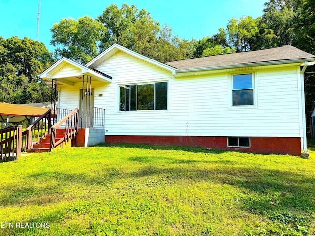 back of property with a lawn