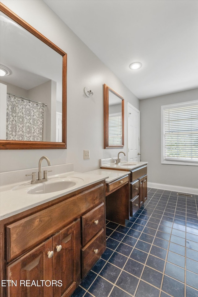 bathroom featuring tile patterned flooring and vanity