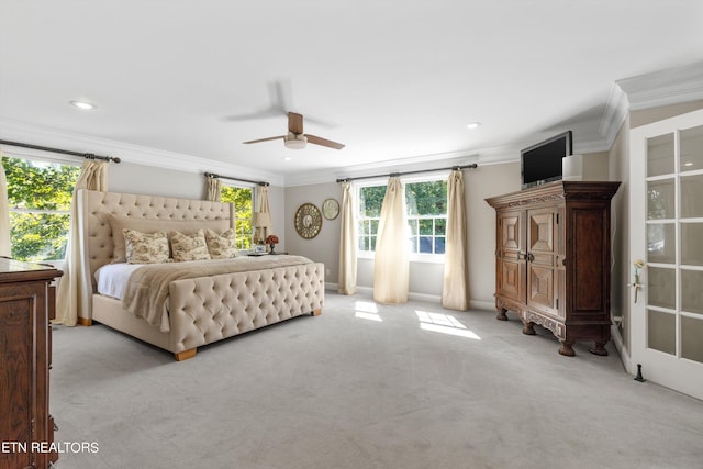 carpeted bedroom with crown molding and ceiling fan