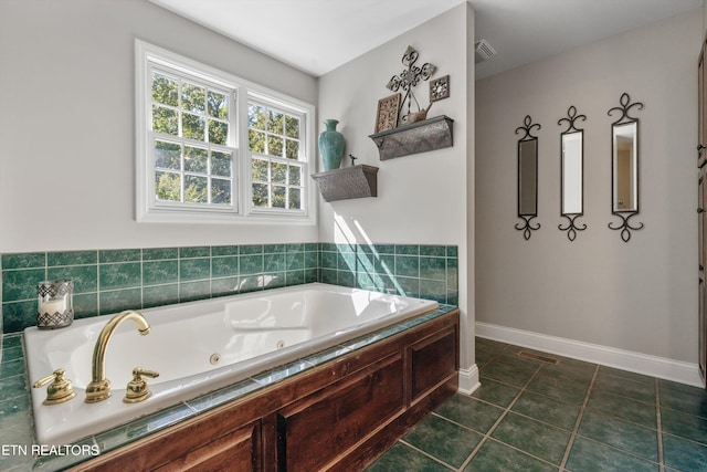 bathroom with tiled bath and tile patterned floors