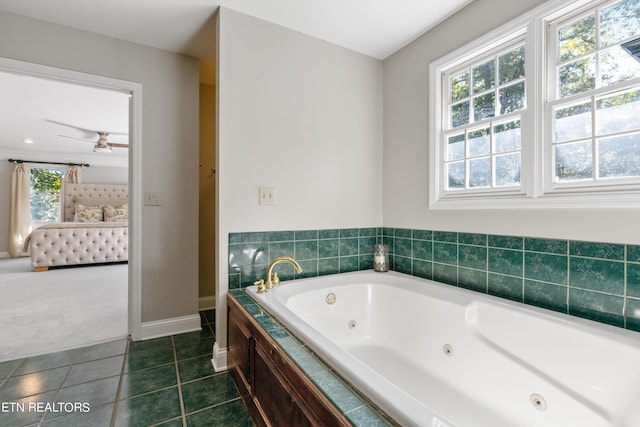 bathroom featuring tile patterned flooring, tiled tub, and ceiling fan