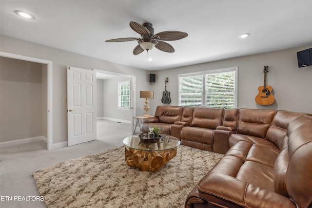 living room with ceiling fan and light colored carpet