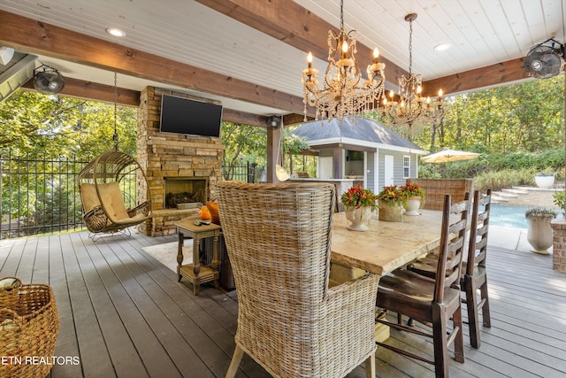 wooden terrace with an outdoor stone fireplace