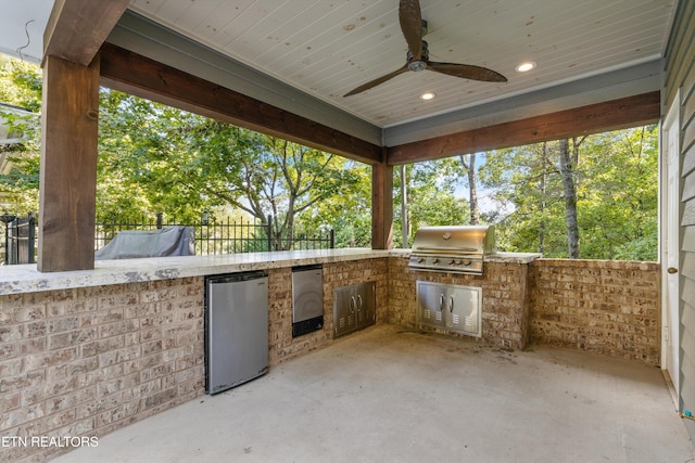 view of patio / terrace with ceiling fan, grilling area, and exterior kitchen