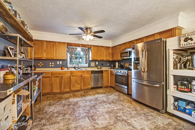 kitchen featuring stainless steel appliances, sink, and crown molding