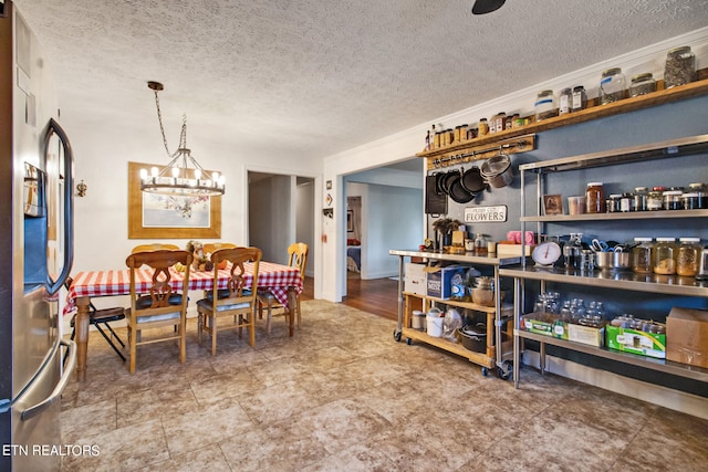 dining room featuring a chandelier and a textured ceiling