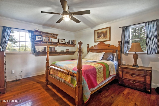 bedroom with ceiling fan, a textured ceiling, dark hardwood / wood-style floors, and crown molding