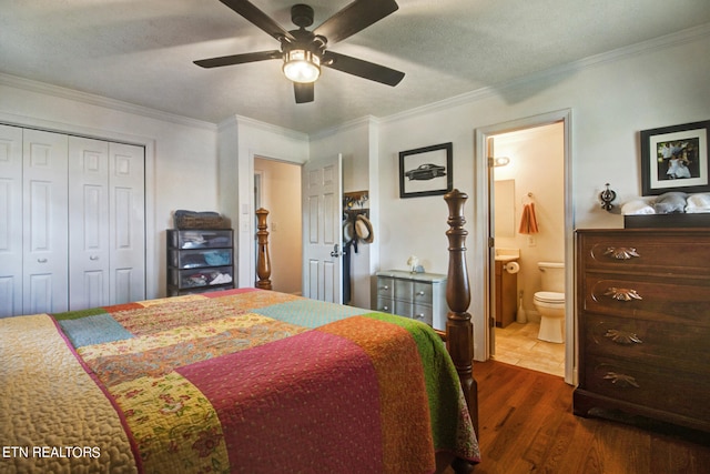 bedroom with dark hardwood / wood-style flooring, a closet, ensuite bath, crown molding, and ceiling fan