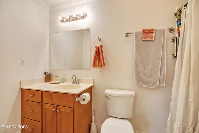 bathroom featuring ornamental molding, vanity, and toilet