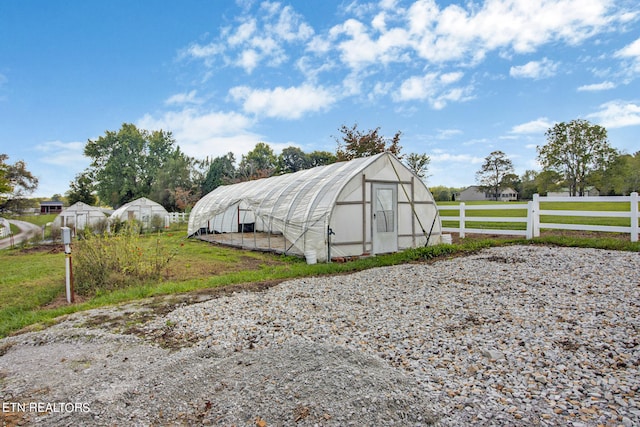 view of outbuilding with a yard and a rural view