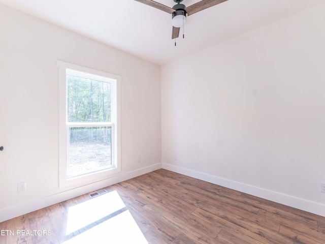 unfurnished room featuring ceiling fan and hardwood / wood-style floors