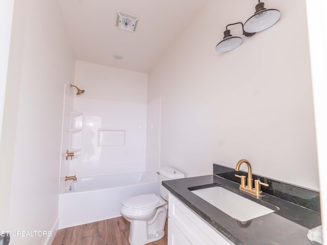 full bathroom featuring vanity, hardwood / wood-style floors, toilet, and bathing tub / shower combination