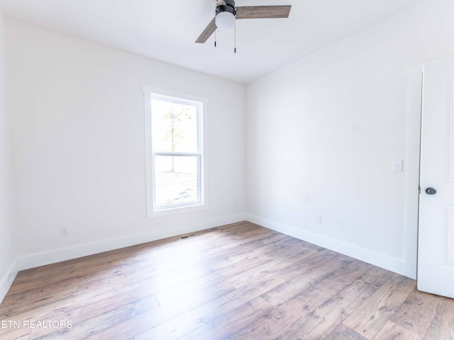 empty room with ceiling fan and light wood-type flooring