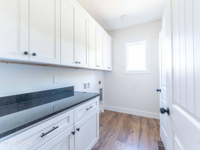 laundry area with hookup for a washing machine, dark hardwood / wood-style flooring, electric dryer hookup, and cabinets