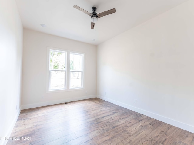 spare room featuring ceiling fan and light wood-type flooring