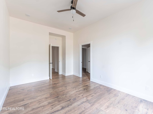 spare room with ceiling fan and light hardwood / wood-style flooring