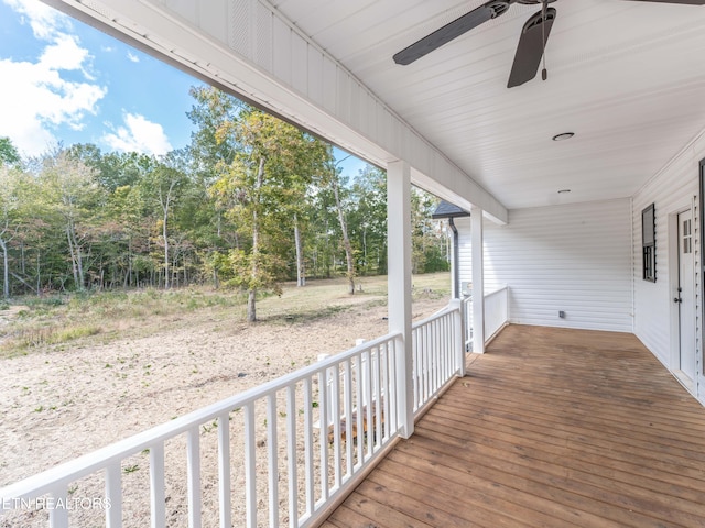 deck with ceiling fan and covered porch