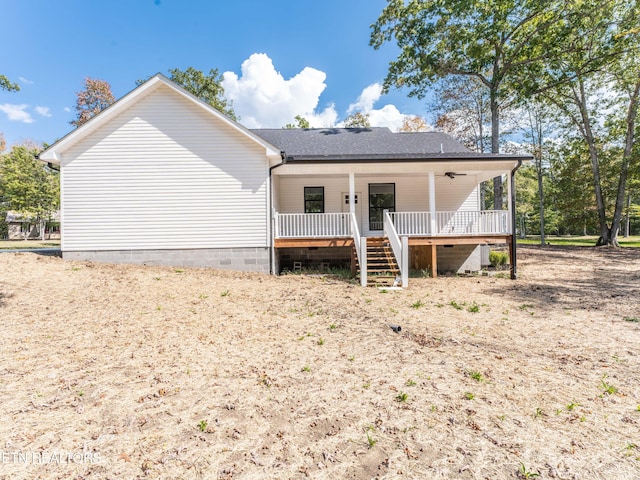 rear view of property with a wooden deck and ceiling fan