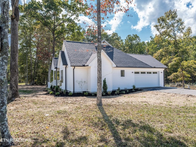 view of property exterior with a lawn and a garage