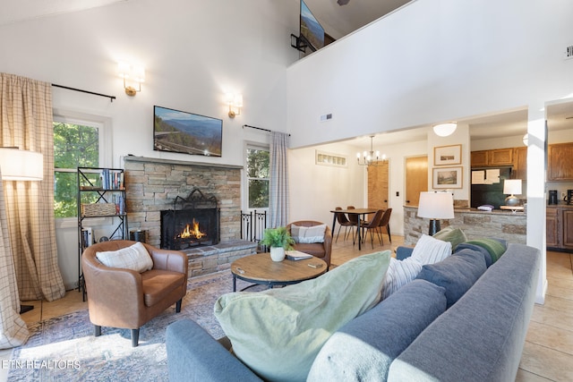 tiled living room featuring a towering ceiling and a stone fireplace