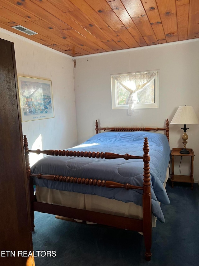 bedroom featuring carpet flooring, wooden walls, and wooden ceiling