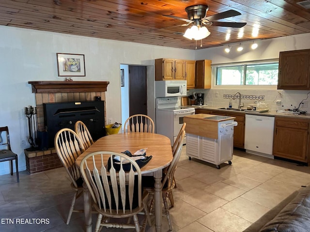 kitchen with backsplash, white appliances, sink, wooden ceiling, and light tile patterned flooring