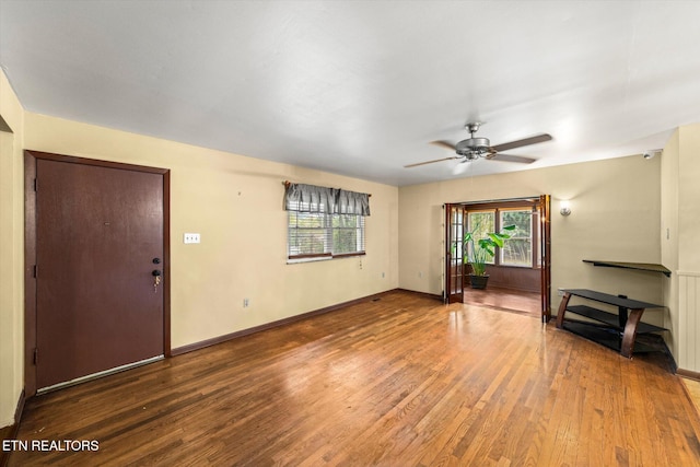 unfurnished living room with wood-type flooring and ceiling fan