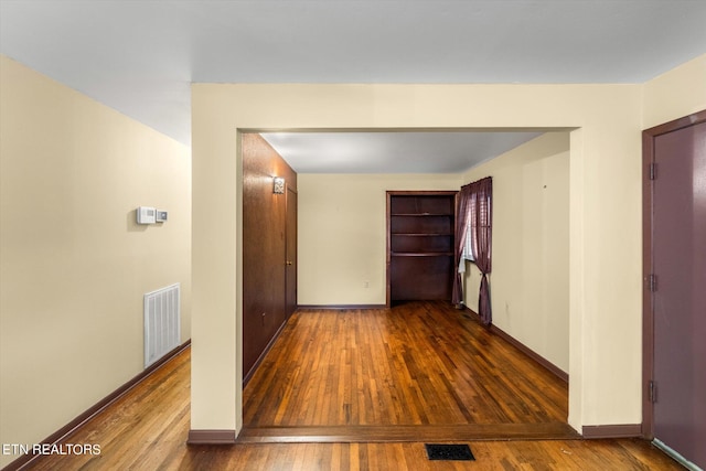 hallway featuring wood-type flooring