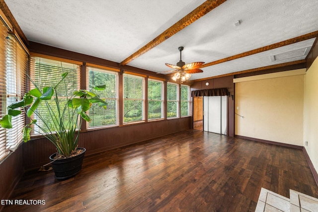 unfurnished sunroom with beamed ceiling and ceiling fan