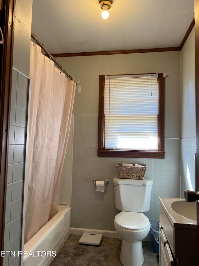 full bathroom with vanity, toilet, tile walls, and shower / tub combo