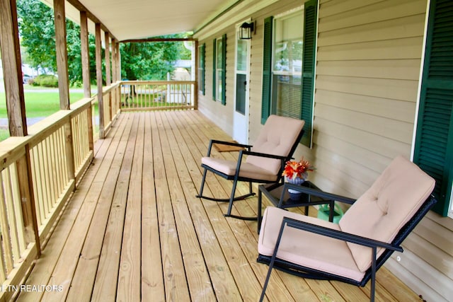 wooden terrace featuring a porch