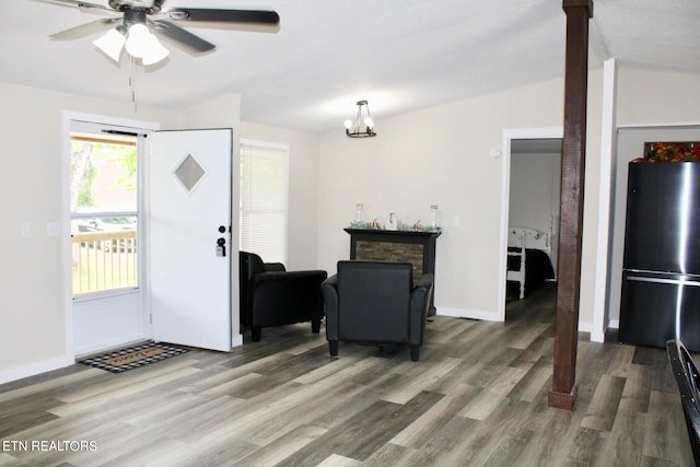 entryway featuring ceiling fan, hardwood / wood-style flooring, a fireplace, and lofted ceiling