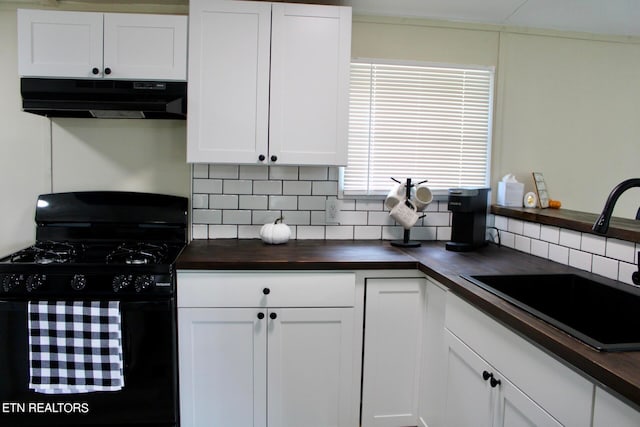 kitchen with decorative backsplash, black range with gas stovetop, sink, and white cabinetry