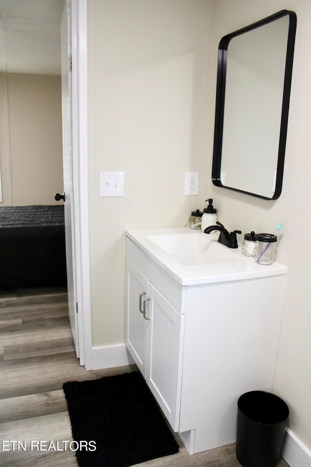 bathroom featuring wood-type flooring and vanity