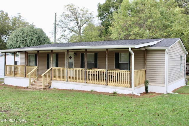 ranch-style house featuring a front yard and covered porch