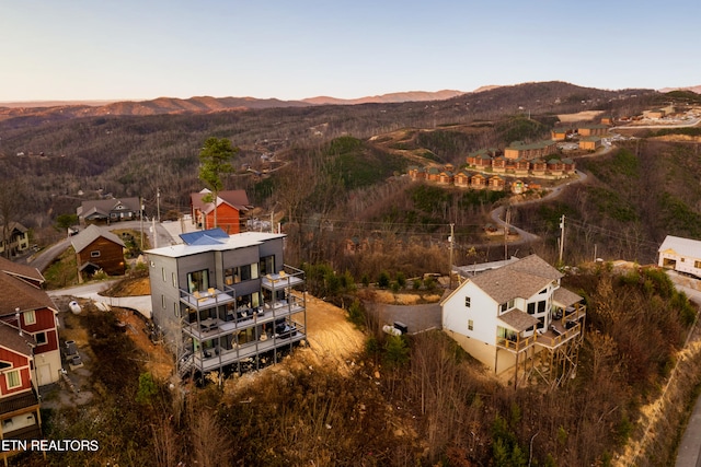 aerial view at dusk featuring a mountain view