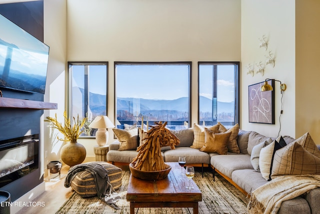 living room with a high ceiling and a mountain view