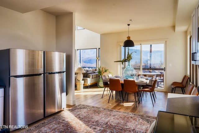 dining area featuring a mountain view and light hardwood / wood-style flooring