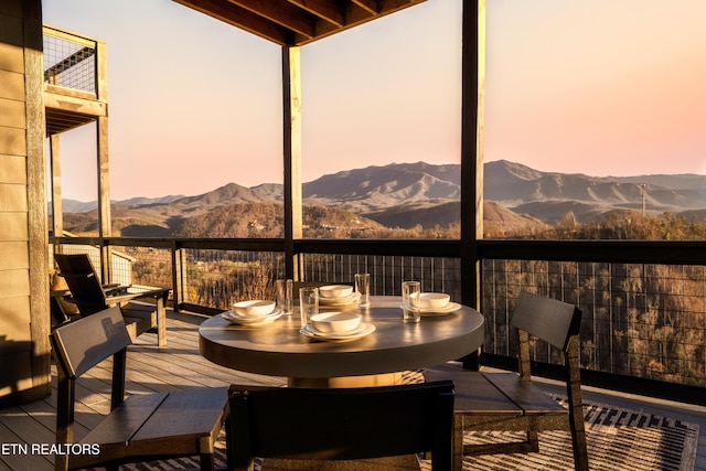 sunroom / solarium featuring a mountain view and beam ceiling