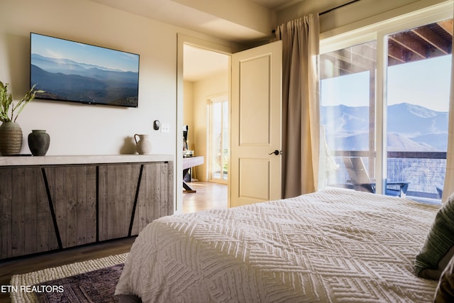 bedroom featuring a mountain view and hardwood / wood-style floors