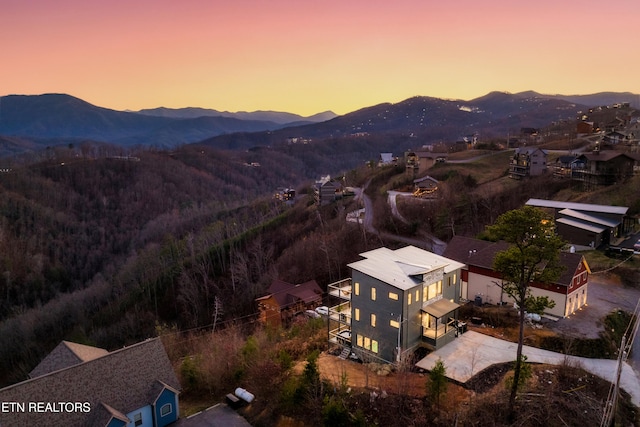 aerial view at dusk featuring a mountain view