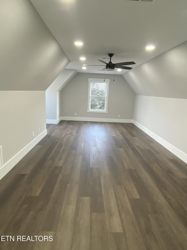 bonus room featuring ceiling fan, dark wood-type flooring, and lofted ceiling