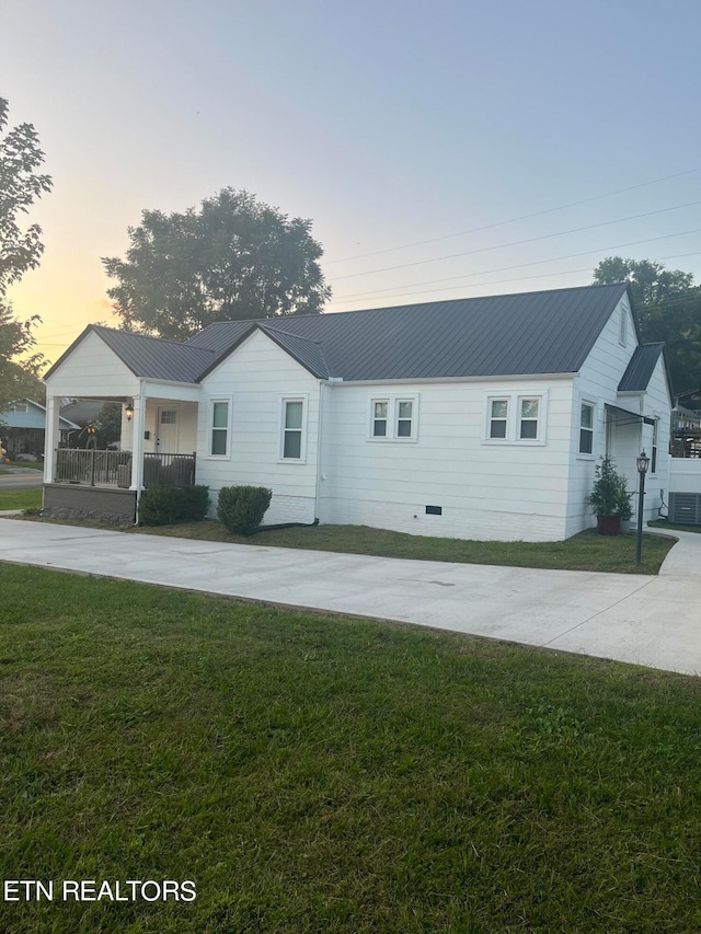 single story home with a yard and central air condition unit