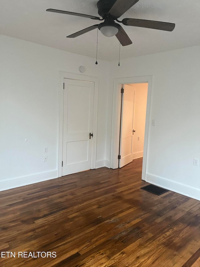 spare room with ceiling fan and dark hardwood / wood-style floors