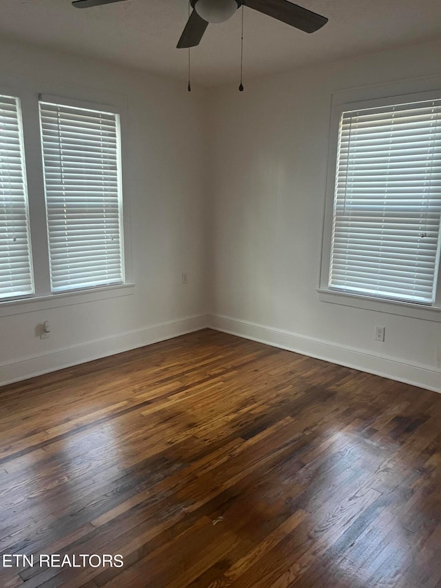 unfurnished room featuring ceiling fan and dark wood-type flooring