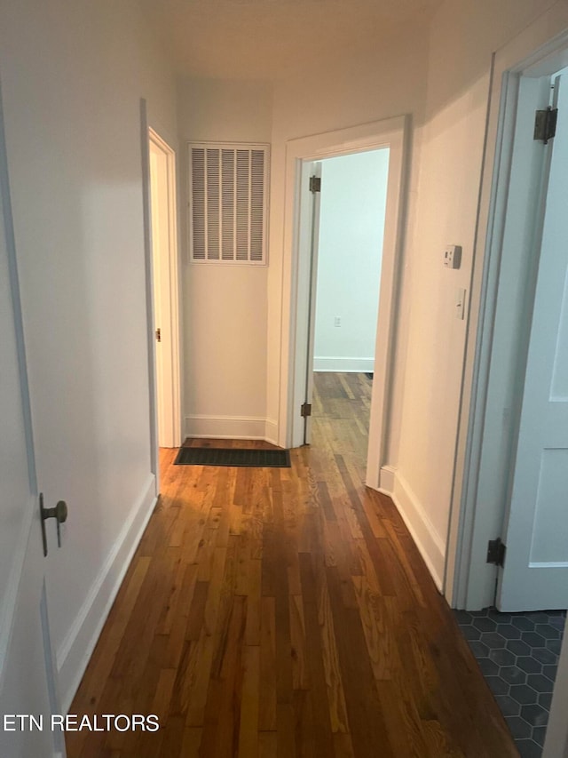 hallway featuring dark hardwood / wood-style flooring