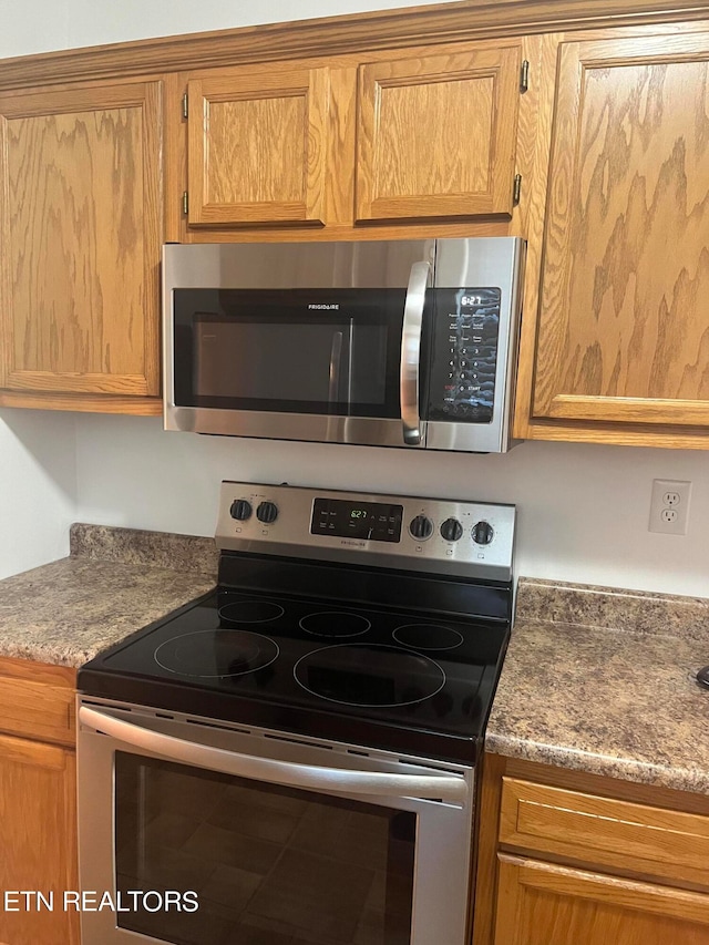 kitchen with light stone countertops and stainless steel appliances